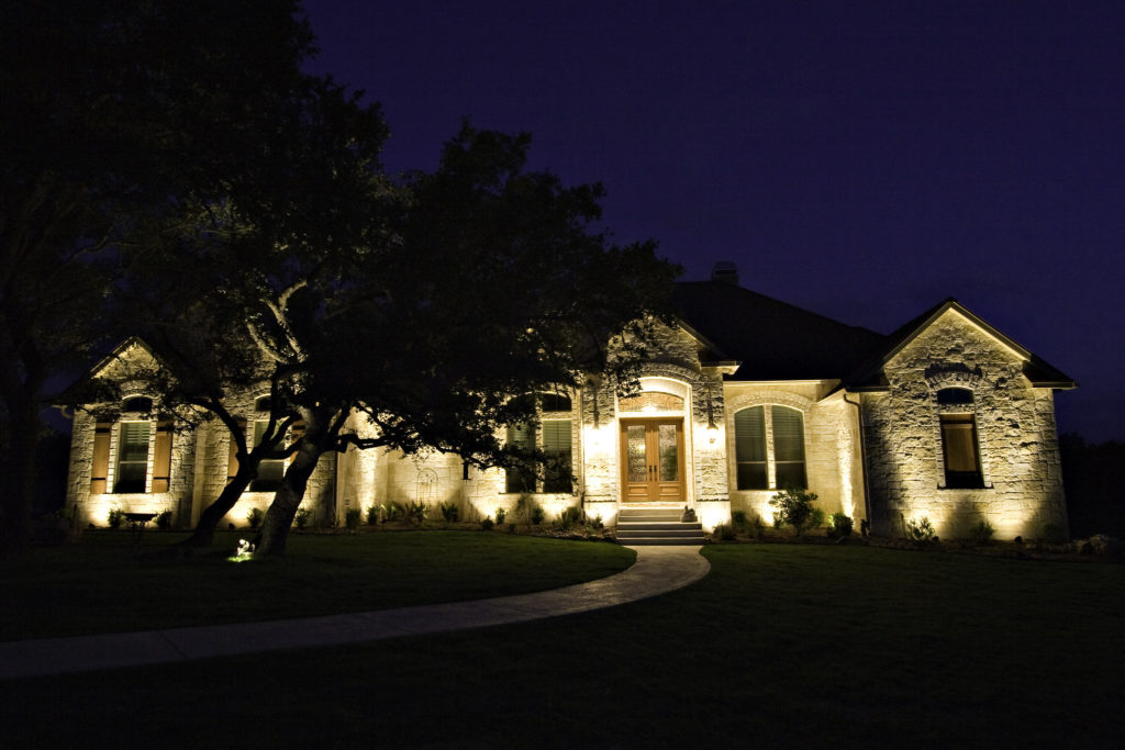 Wall wash lighting illuminates the front of a house