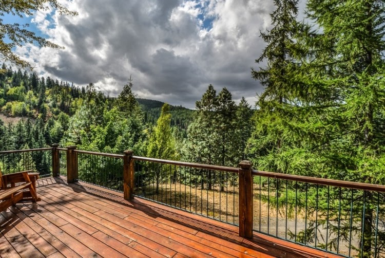 Wooden deck with a view of a large forest