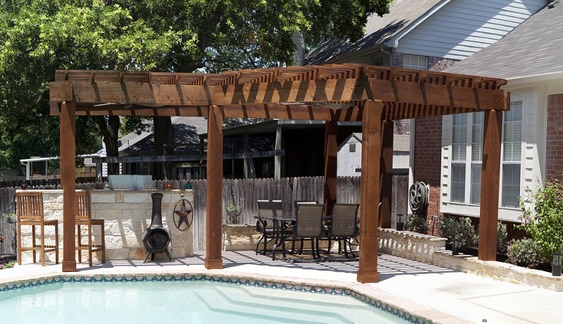 Wood pergola covering a poolside seating area