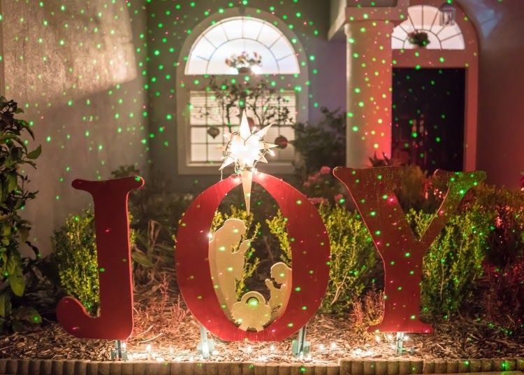 Red letters that spell out "Joy" with small nativity inside the "O"