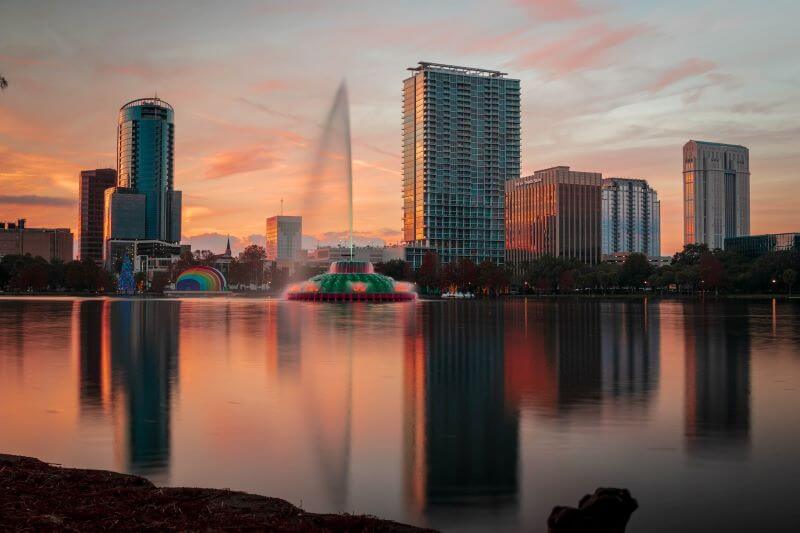 A twilight view of the Orlando, Florida, skyline reflecting on Lake Eola