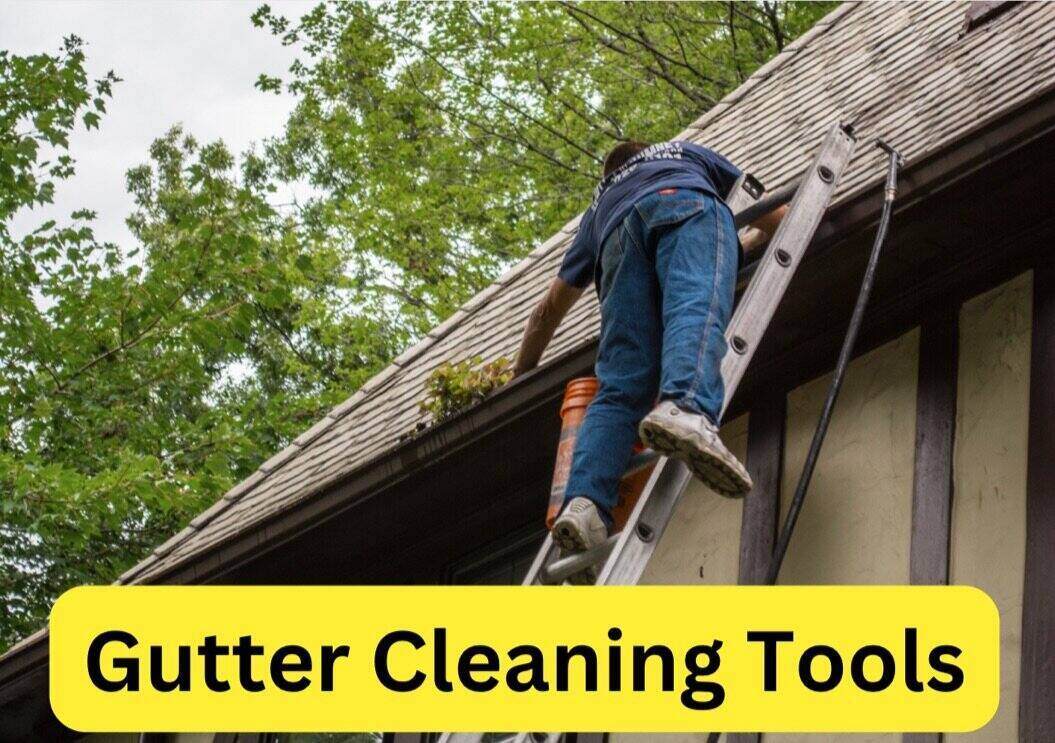Man on a ladder cleaning the gutters