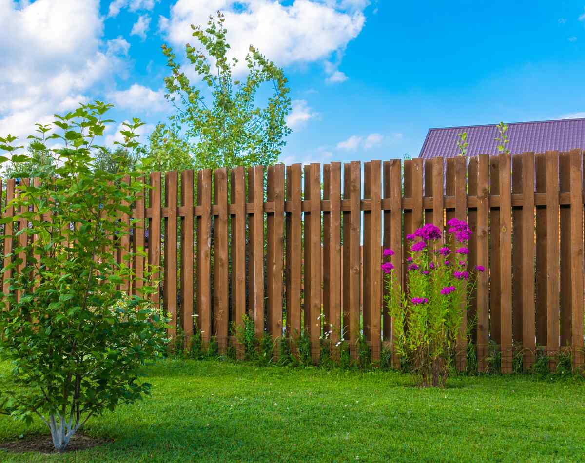 A beautiful wooden fence of a lawn