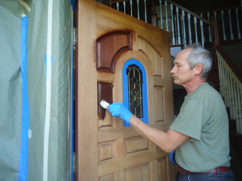 person painting a door