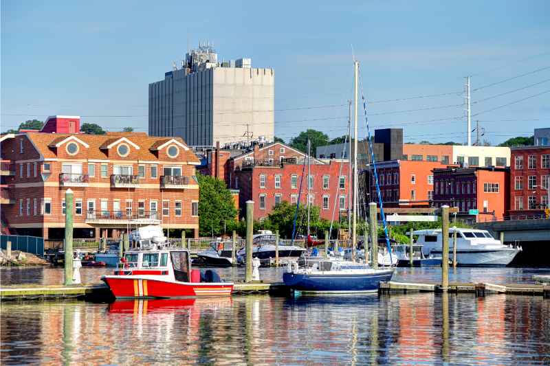boats in a river with buildings in background