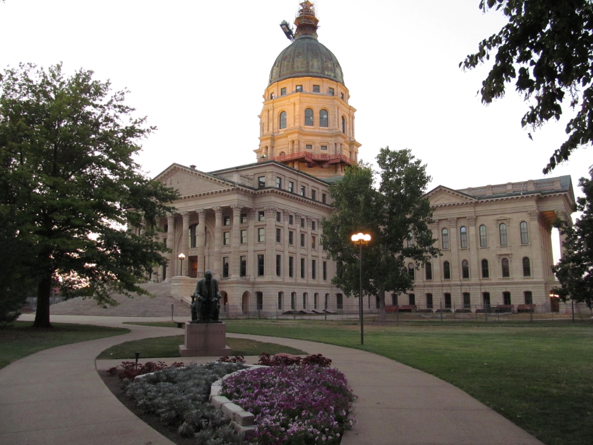 The Topeka, Kansas capital building with a green lawn