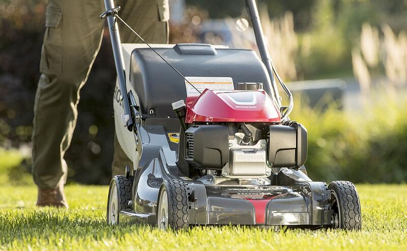 man pushing a lawn mower
