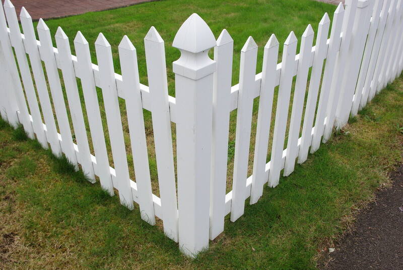 Corner of a white vinyl fence