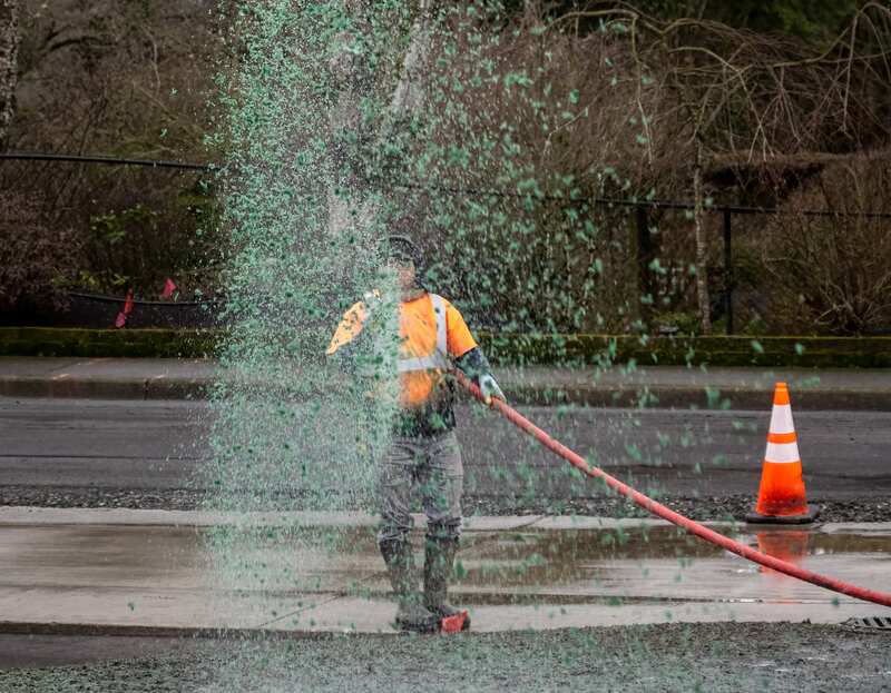 professional worker hydroseeding a lawn