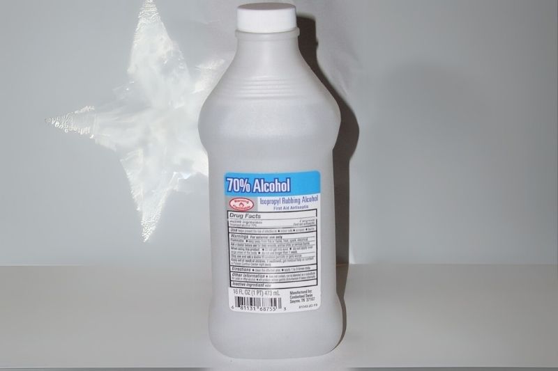 a bottle of rubbing alcohol on a surface