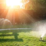 Landscape automatic garden watering system with different sprinklers installed under turf.